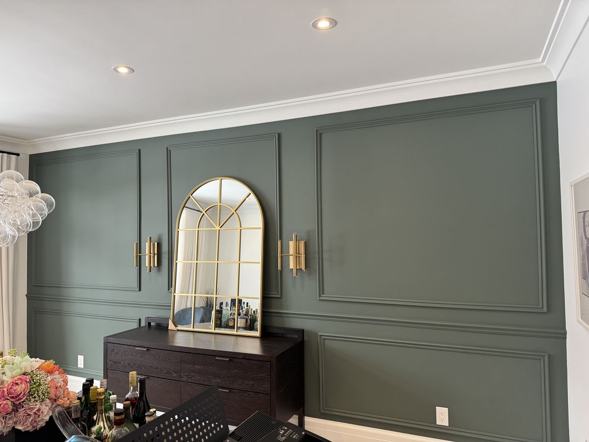 Sage green wainscoting feature wall in a dining room