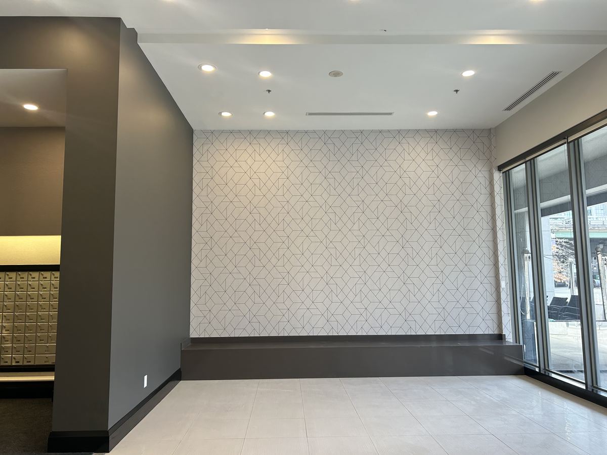 Geometric wallpaper feature wall in a condo building lobby